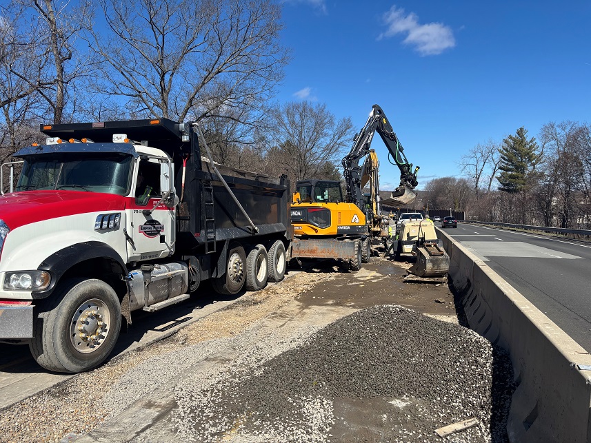 Photo of construction vehicle and excavator for median work